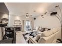 Cozy living room featuring a decorative fireplace, plush seating, and a ceiling fan at 2050 W Warm Springs Rd # 3624, Henderson, NV 89014