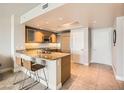 Well-lit kitchen features granite countertops, stainless steel appliances, and bar stool seating at 222 Karen Ave # 2305, Las Vegas, NV 89109
