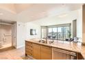 Kitchen with granite countertops and stainless appliances overlooks city views from the adjacent living area at 222 Karen Ave # 2305, Las Vegas, NV 89109