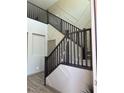 View of staircase with dark wood railing and decorative wall paneling at 2645 Cava Tirreni St, Henderson, NV 89044