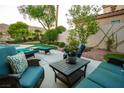 Relaxing patio area featuring plush seating with mountain views in a landscaped backyard at 2837 Turtle Head Peak Dr, Las Vegas, NV 89135