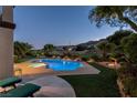 Inviting pool and jacuzzi offers a relaxing outdoor space with a view of the nearby golf course and mountains at 2837 Turtle Head Peak Dr, Las Vegas, NV 89135