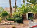 The building exterior features professional landscaping, a red tile roof, and mature palm trees around the building at 3055 Key Largo Dr # 204, Las Vegas, NV 89120