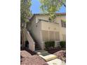 The exterior of the home shows a small balcony, screened-in porch, and stairs to the main level at 3055 Key Largo Dr # 204, Las Vegas, NV 89120