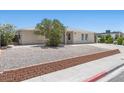 Updated single-story home with low maintenance landscaping and a brick retaining wall at 321 Oil Lantern Ln, Las Vegas, NV 89145
