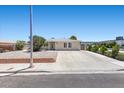Well-maintained home with desert landscaping, a spacious driveway, and ample parking at 321 Oil Lantern Ln, Las Vegas, NV 89145
