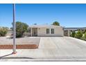 Single-story home featuring a large driveway, neutral exterior, and low-maintenance landscaping at 321 Oil Lantern Ln, Las Vegas, NV 89145