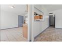 Open-concept living space featuring tiled floors and access to the kitchen, laundry, and hallway at 3684 Hawaii Ave, Las Vegas, NV 89104