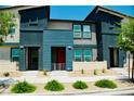 Charming townhouse with eye-catching blue accents and manicured landscaping, creating an appealing curb presence at 3763 Sonrisa Vista Ave, Henderson, NV 89044