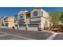 Well-maintained stucco building with individual garages in a desirable neighborhood with manicured landscaping at 3936 Pepper Thorn Ave # 3, North Las Vegas, NV 89081