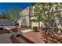 Charming townhouse with a welcoming entrance, lovely landscaping and shade trees, enhancing its curb appeal at 3936 Pepper Thorn Ave # 3, North Las Vegas, NV 89081