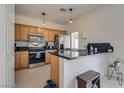 Well-equipped kitchen features stainless steel appliances, black countertops, and wooden cabinets at 3936 Pepper Thorn Ave # 3, North Las Vegas, NV 89081