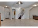 Spacious living room showcasing tile flooring, a staircase, and ample natural light at 3936 Pepper Thorn Ave # 3, North Las Vegas, NV 89081
