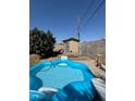 Backyard featuring an inflatable pool, storage shed, and privacy fence, great for relaxation at 4503 Springdale Ave, Las Vegas, NV 89121