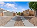 Long driveway leading up to a single-story home with desert landscaping and gated RV parking at 5115 Morning Splash Ave, Las Vegas, NV 89131