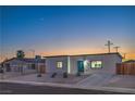 Charming single-story home featuring a modern exterior, desert landscaping, and a freshly paved driveway at 5200 Blanton Dr, Las Vegas, NV 89122