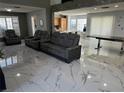 Spacious living room featuring dual sofas, large windows, and sleek marble flooring at 6208 Mandarin Dr, Las Vegas, NV 89108