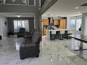 Open-concept living room with a kitchen island and comfortable seating at 6208 Mandarin Dr, Las Vegas, NV 89108