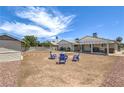 A big backyard with potential featuring a covered patio and space for outdoor entertaining at 6920 Singing Dunes Ln, Las Vegas, NV 89145