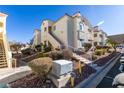 Attractive condo exterior with landscaped grounds, stairs, and well-maintained surroundings at 698 S Racetrack Rd # 711, Henderson, NV 89015