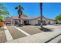 A well-kept single-story home showing a tile roof and desert landscaping with an extended driveway at 715 Heritage Point Dr, Henderson, NV 89002