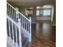 A spacious living room with hardwood floors and bright windows offering a view of an adjacent kitchen and dining area at 7160 Mineral Park Ave, Las Vegas, NV 89179