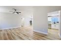 Open living area with wood-look floors and neutral walls leading to the kitchen at 744 Hubbard St, Las Vegas, NV 89110