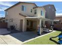 A spacious backyard featuring a covered patio, artificial turf, and play areas at 7468 Wellfleet Bay Ave, Las Vegas, NV 89179