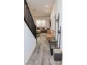 Bright living room with neutral decor, modern staircase, and stylish wood-look floors. Perfect for relaxing and entertaining at 7468 Wellfleet Bay Ave, Las Vegas, NV 89179