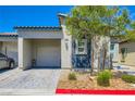Charming single-story home with a well-manicured front yard and a private two-car garage at 7533 Garnet Moon St, North Las Vegas, NV 89084