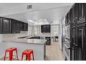 Modern kitchen features dark wood cabinetry, granite countertops, and stainless steel appliances at 7627 Boca Raton Dr, Las Vegas, NV 89113