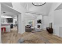 Bright living room featuring modern decor, a fireplace, and an open layout to the kitchen at 7627 Boca Raton Dr, Las Vegas, NV 89113