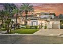 Beautiful two-story home featuring a well-manicured lawn, palm trees, and a spacious driveway at 764 Ricota Ct, Henderson, NV 89012