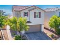 Charming two-story home featuring desert landscaping and a brown garage door at 7990 Formitch Ct, Las Vegas, NV 89166