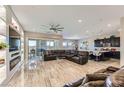 Spacious living room boasts tile floors, a ceiling fan, and a cozy fireplace entertainment center at 800 Rosewater Dr, Henderson, NV 89011
