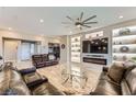 Bright living room showcasing a modern fireplace, built-in shelving and recessed lighting at 800 Rosewater Dr, Henderson, NV 89011