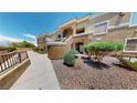 Attractive multi-level apartment building features well-maintained landscaping, rock beds, and inviting common areas at 8070 W Russell Rd # 1046, Las Vegas, NV 89113