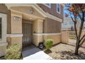 Inviting entrance with decorative door and landscaping, leading to a charming townhome at 8639 Horizon Wind Ave # 102, Las Vegas, NV 89178