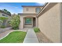 Inviting front entrance with walkway, manicured lawn and garden at 9044 Blue Raven Ave # R, Las Vegas, NV 89143