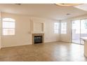 Spacious living room with tile flooring, a fireplace, and large windows at 1012 Collingtree St, Las Vegas, NV 89145