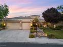 Inviting single-story home with a three-car garage, manicured lawn, and beautiful landscaping at 1016 Sable Mist Ct, Las Vegas, NV 89144