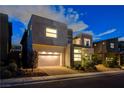 Contemporary home featuring a two-car garage, modern design, and desert-friendly landscaping at 10752 Patina Hills Ct, Las Vegas, NV 89135