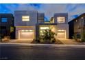 Striking modern home featuring a well-manicured front yard, two-car garage, and contemporary design at 10752 Patina Hills Ct, Las Vegas, NV 89135