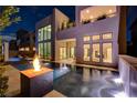 Stunning backyard pool with fire feature, manicured landscaping, and inviting lounge area at twilight at 10752 Patina Hills Ct, Las Vegas, NV 89135
