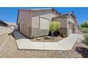 Lovely home featuring a stone landscape, well kept lawn, and an inviting side entrance at 1076 Crescent Falls St, Henderson, NV 89011