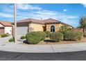 Single-story home featuring a tile roof, well-maintained landscaping, and a welcoming facade at 11253 Revelry Ln, Las Vegas, NV 89138