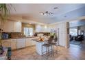 Bright eat-in kitchen with white cabinetry, a center island, and stainless steel appliances at 151 Enloe St, Henderson, NV 89074