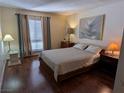 Cozy bedroom with laminate flooring and natural light from the window at 1515 E Reno Ave # C207, Las Vegas, NV 89119