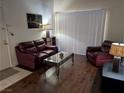 Comfortable living room featuring laminate flooring and a full-size sofa at 1515 E Reno Ave # C207, Las Vegas, NV 89119