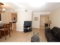 Inviting living room with open access to the kitchen, featuring neutral walls and hardwood floors at 230 E Flamingo Rd # 229, Las Vegas, NV 89169